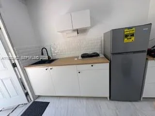 a kitchen with a sink and a refrigerator