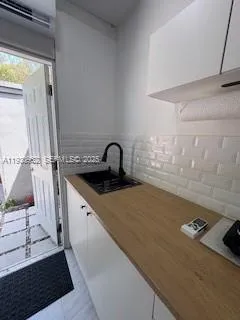 a kitchen with a sink and a stove top oven