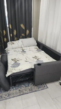 a bed sitting in a bedroom and mirror