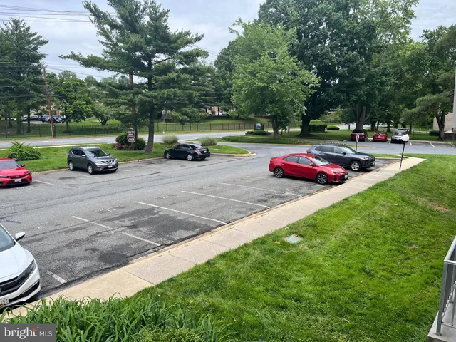 a view of a yard with table and chairs under an umbrella