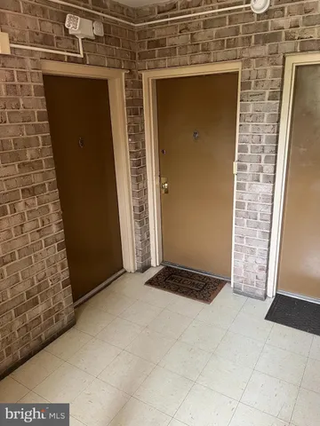 a view of a hallway with furniture and a window