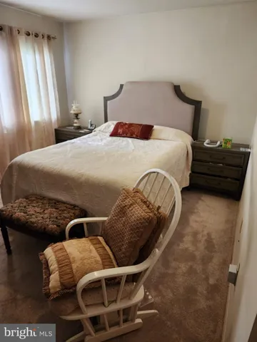 a bedroom with furniture and window