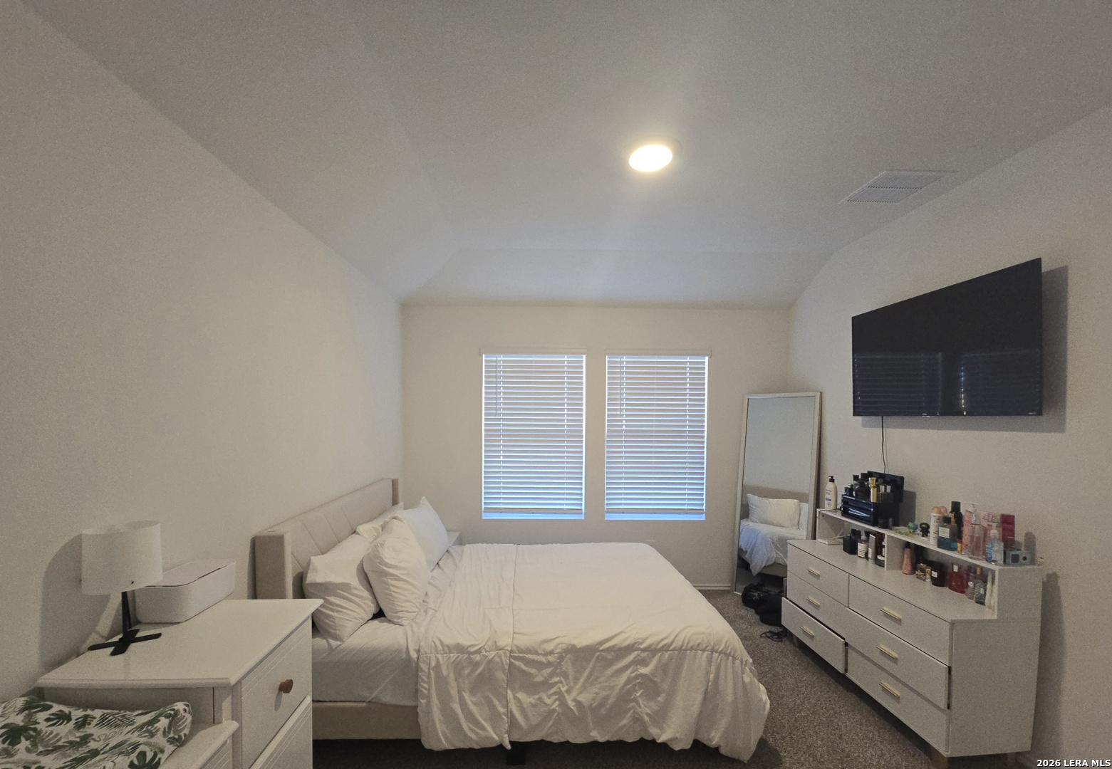 328 Celosia Loop Kyle, TX 78640 - Photo 12 of 29 a bedroom with a bed and flat screen tv