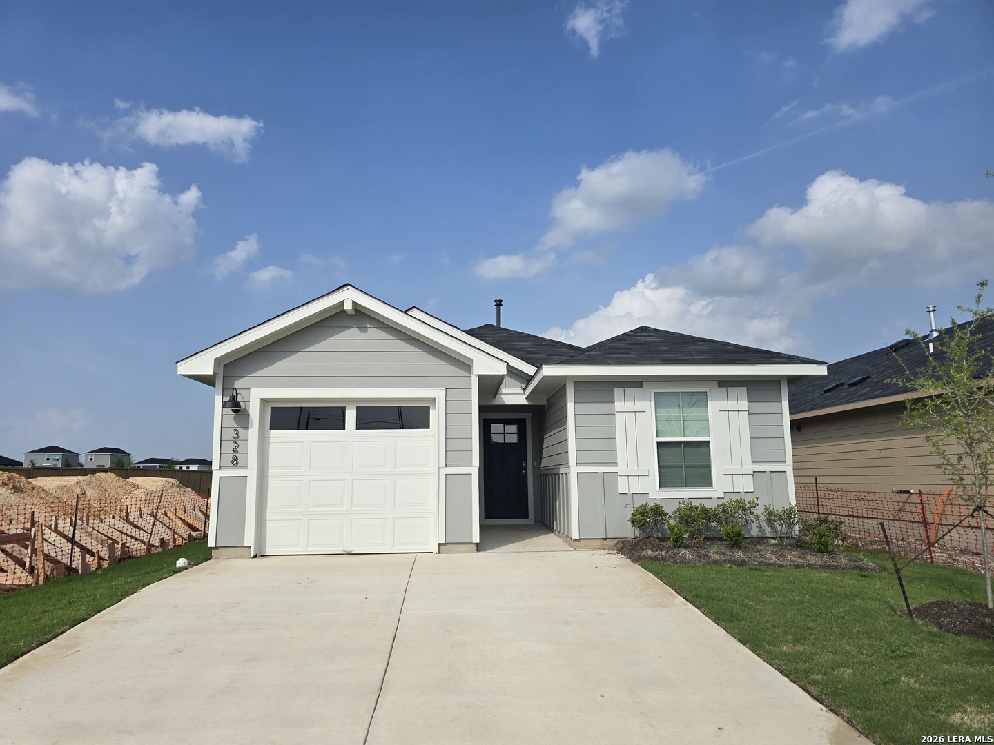 328 Celosia Loop Kyle, TX 78640 - Photo 2 of 29 a front view of a house with a yard and garage