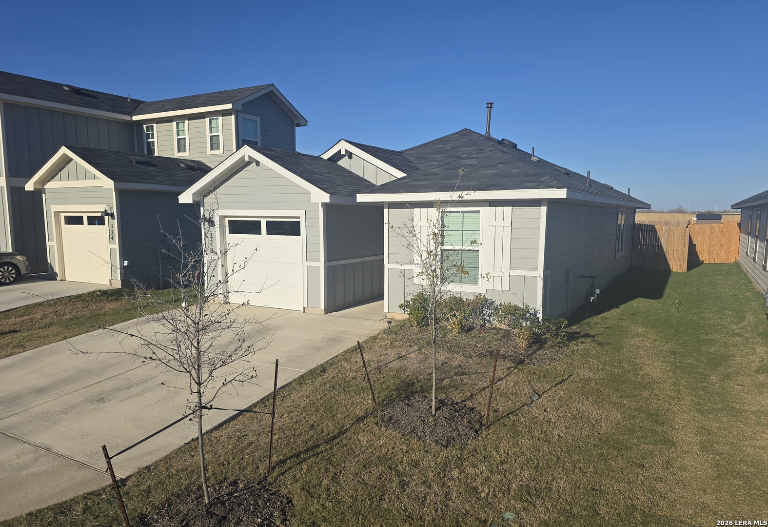 328 Celosia Loop Kyle, TX 78640 - Photo 29 of 29 a front view of a house with a yard and garage