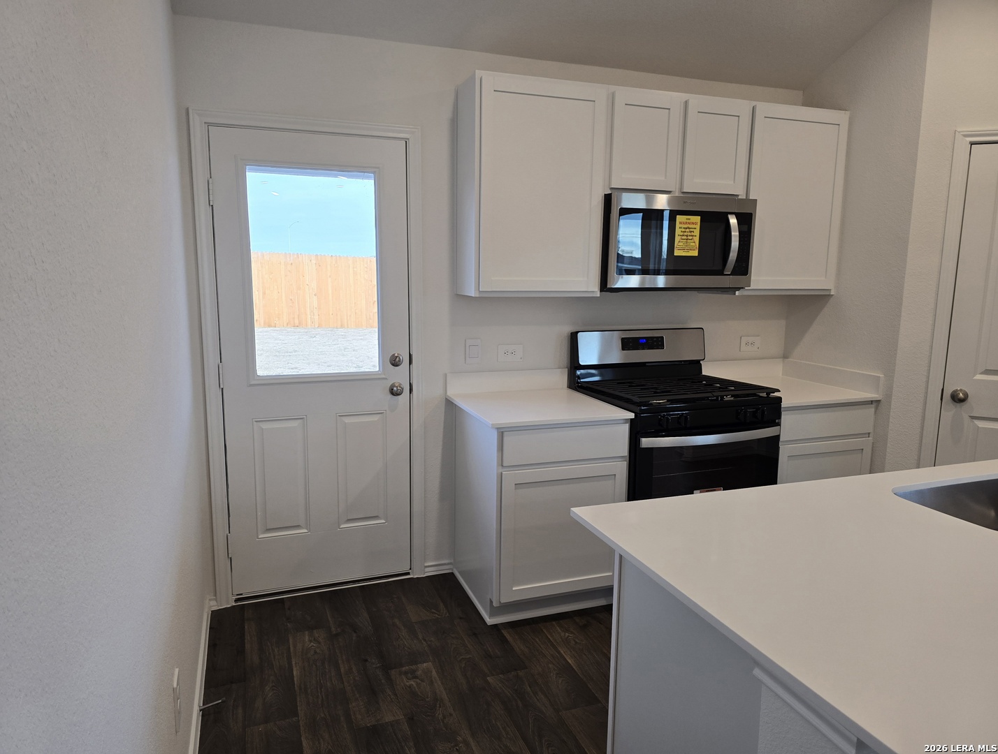 328 Celosia Loop Kyle, TX 78640 - Photo 10 of 29 a kitchen with stainless steel appliances a stove microwave and sink
