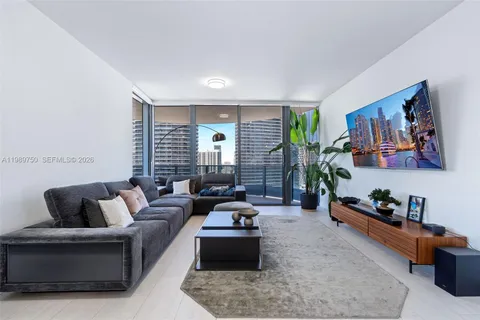 a living room with furniture and a large window