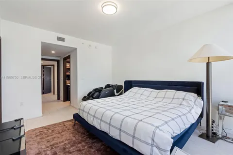 a bedroom with a bed and a lamp