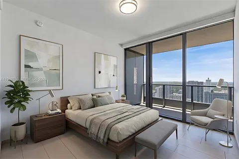 a bedroom with a large bed and a balcony