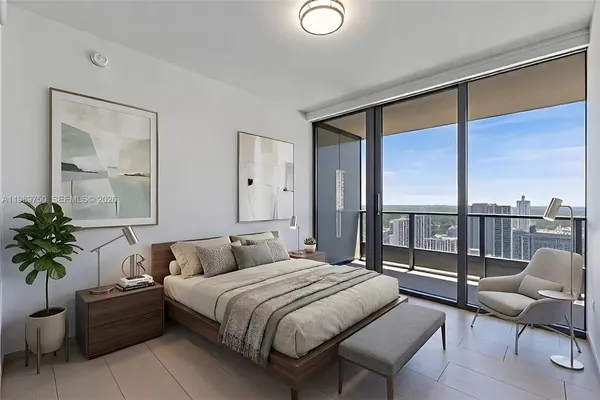a bedroom with a large bed and a balcony