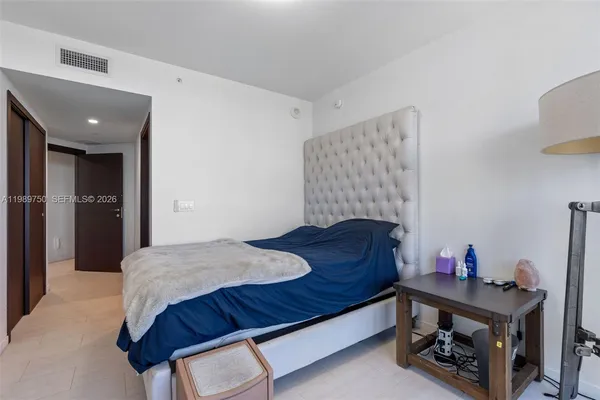 a bedroom with a bed and a dresser in it