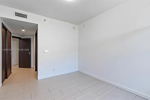 a view of an empty room with windows