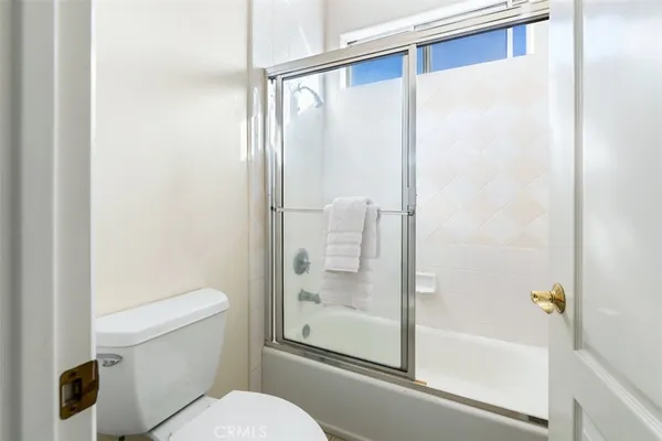 a bathroom with a glass shower door