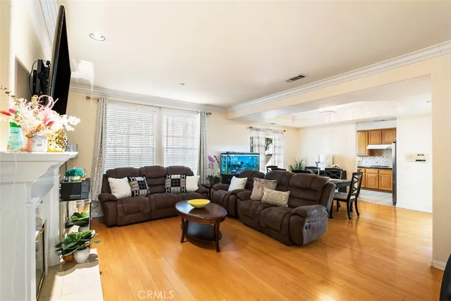 a living room with furniture flat screen tv and a large window