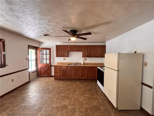 a kitchen with a refrigerator a sink and dishwasher