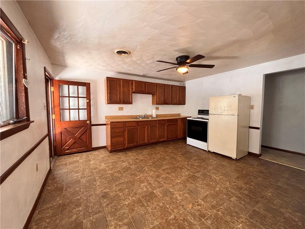 2695 West Chestnut Street, Unit 2 Washington, PA 15301 - Photo 3 of 12 a view of kitchen with furniture and a ceiling fan