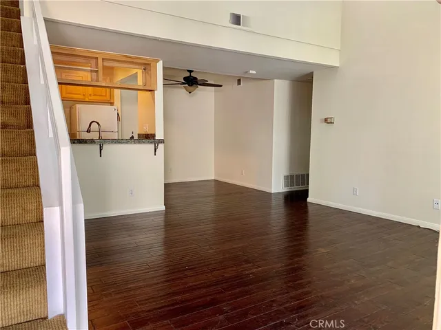 a view of a room with wooden floor and a window