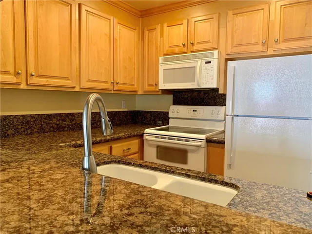 a kitchen with a stove a sink and a microwave