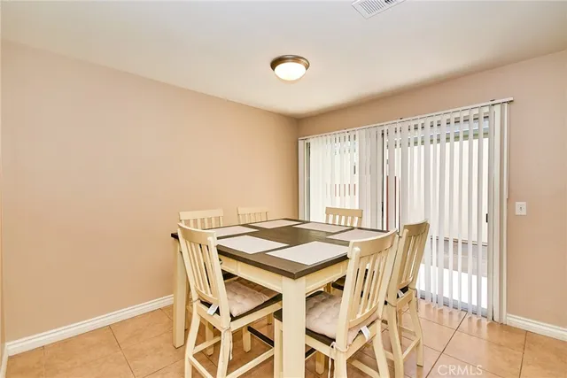 a view of a dining room with furniture and a window