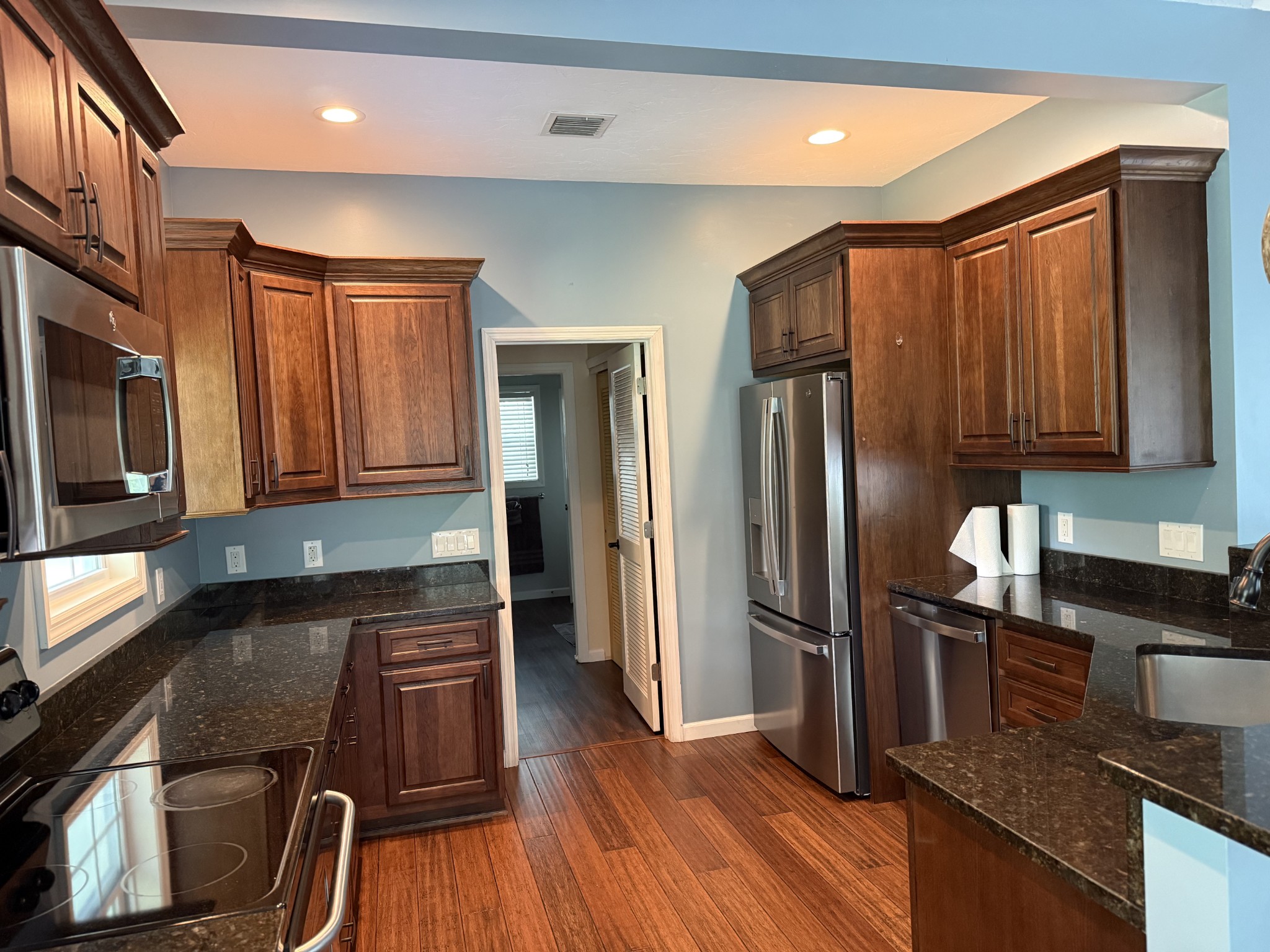 581 Shady Grove Road Bloomington Springs, TN 38545 - Photo 29 of 42 a kitchen with granite countertop stainless steel appliances and wooden cabinets