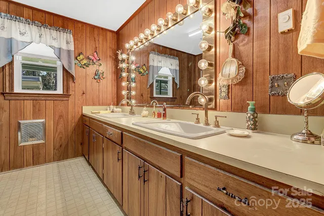 a bathroom with a double vanity sink and a mirror