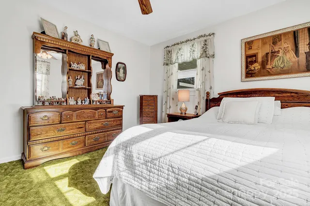 a bedroom with a bed and a dresser