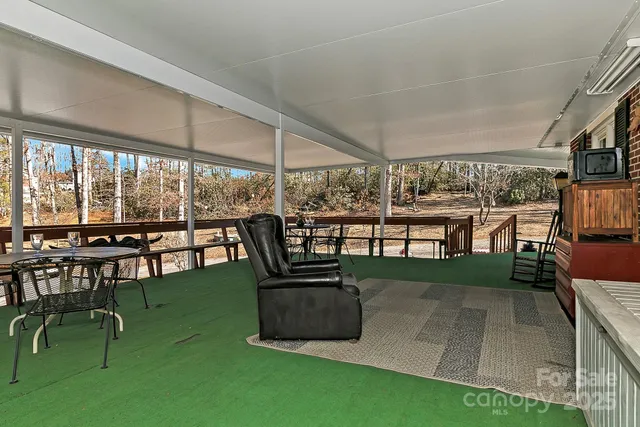 a view of a patio with dining table and chairs