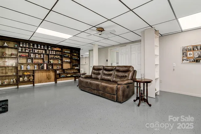 a living room with furniture and a ceiling fan
