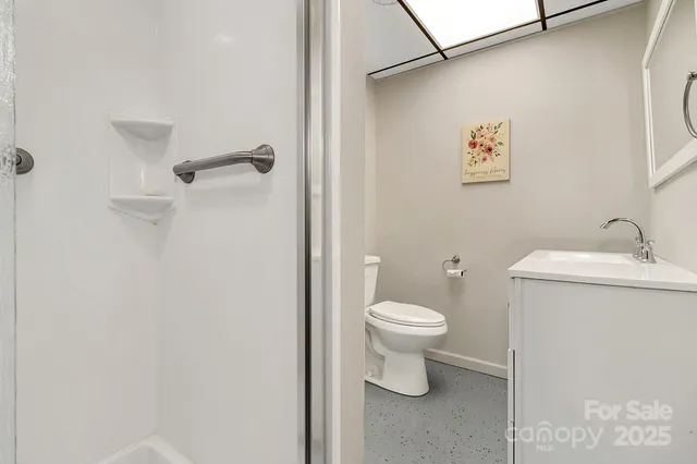a bathroom with a toilet sink and vanity