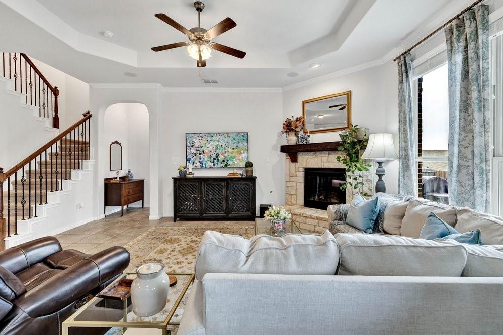 4105 Ranchman Boulevard Denton, TX 76210 - Photo 12 of 39 a living room with furniture a fireplace and a large window