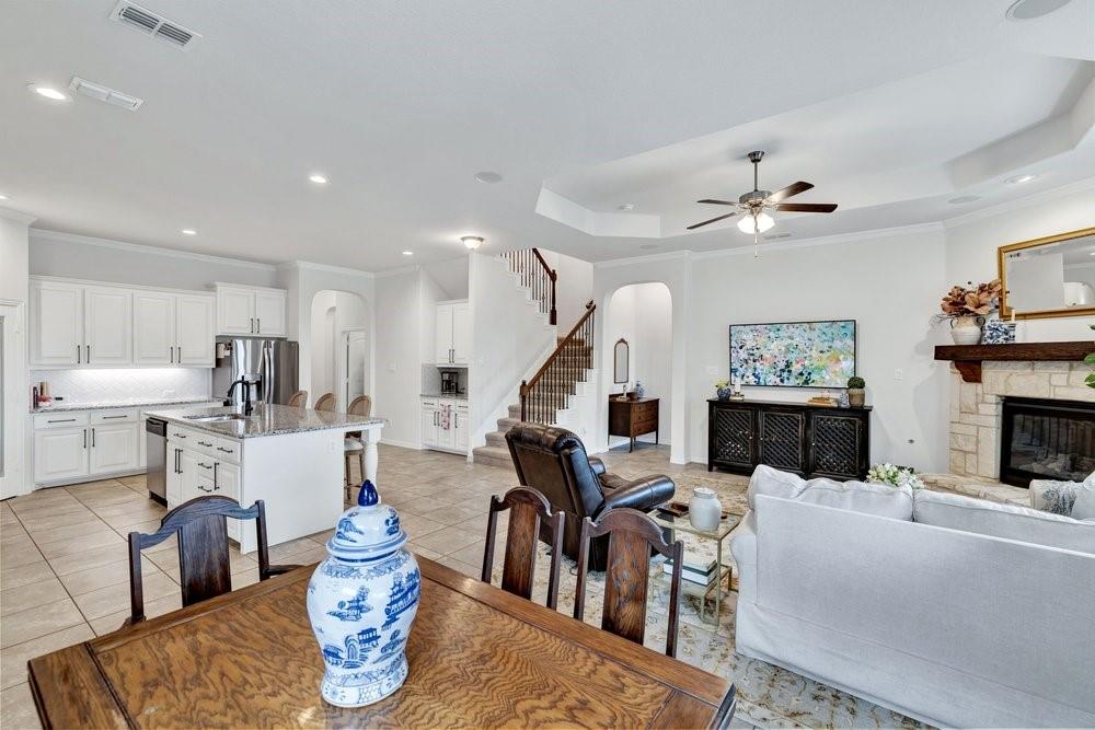 4105 Ranchman Boulevard Denton, TX 76210 - Photo 13 of 39 a living room with furniture kitchen view and a chandelier