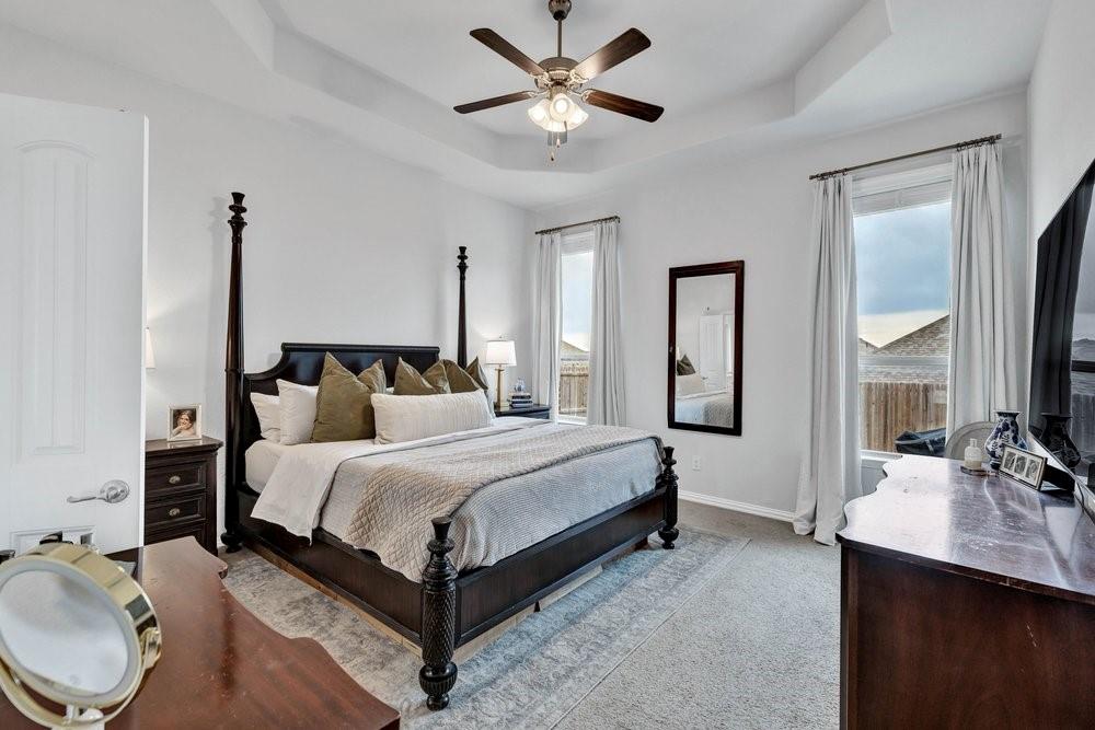 4105 Ranchman Boulevard Denton, TX 76210 - Photo 15 of 39 a bedroom with bed and wooden floor