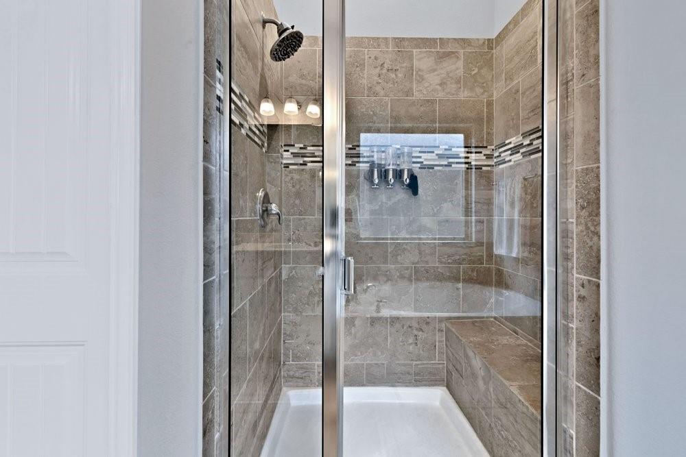 4105 Ranchman Boulevard Denton, TX 76210 - Photo 18 of 39 a bathroom with a glass shower door