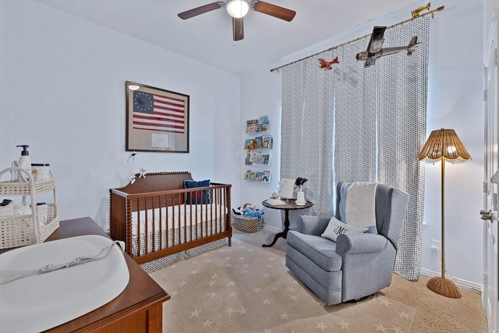 4105 Ranchman Boulevard Denton, TX 76210 - Photo 21 of 39 a bedroom with furniture and a window