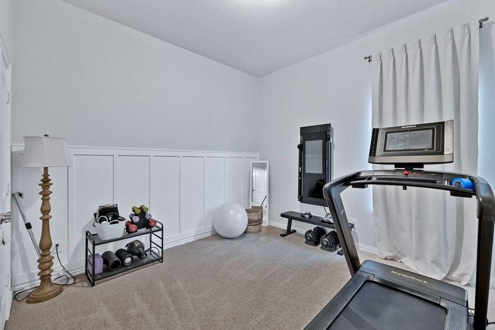 4105 Ranchman Boulevard Denton, TX 76210 - Photo 24 of 39 a room with a chair and gym equipment