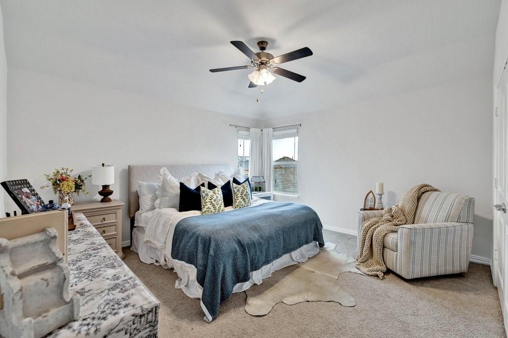 4105 Ranchman Boulevard Denton, TX 76210 - Photo 30 of 39 a bedroom with bed and a couch