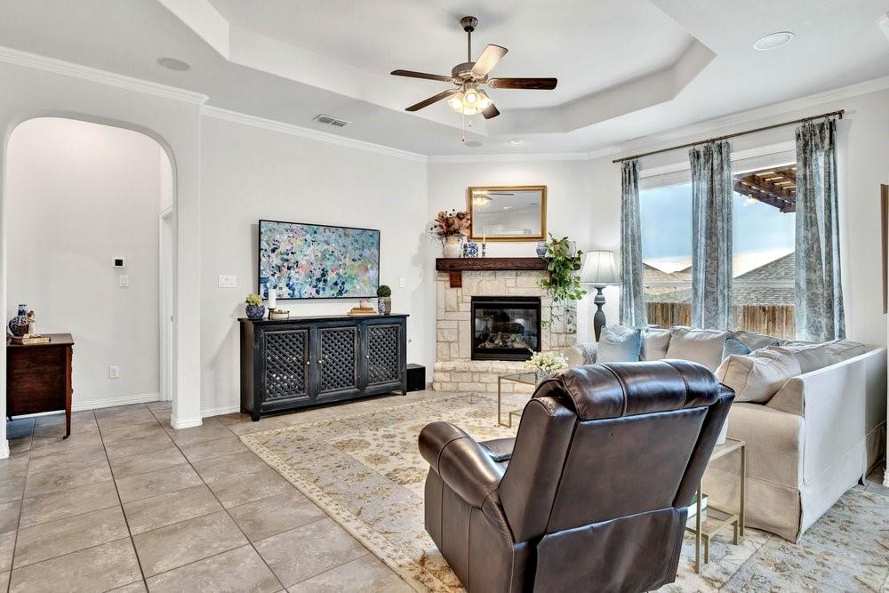 4105 Ranchman Boulevard Denton, TX 76210 - Photo 7 of 39 a living room with furniture a large window and a fireplace