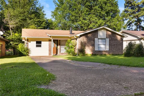 a front view of house with yard and green space