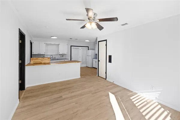 a view of a kitchen with wooden floor