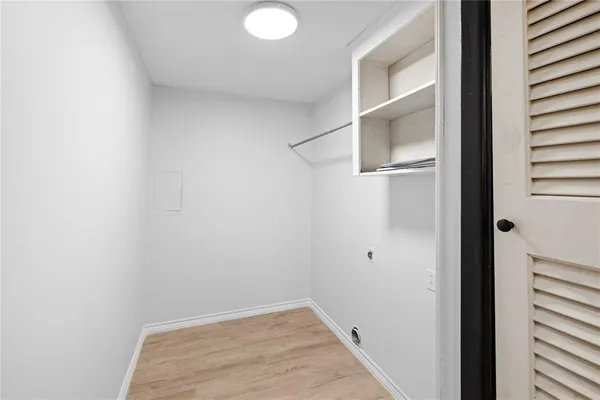 a large white kitchen with a sink and dishwasher