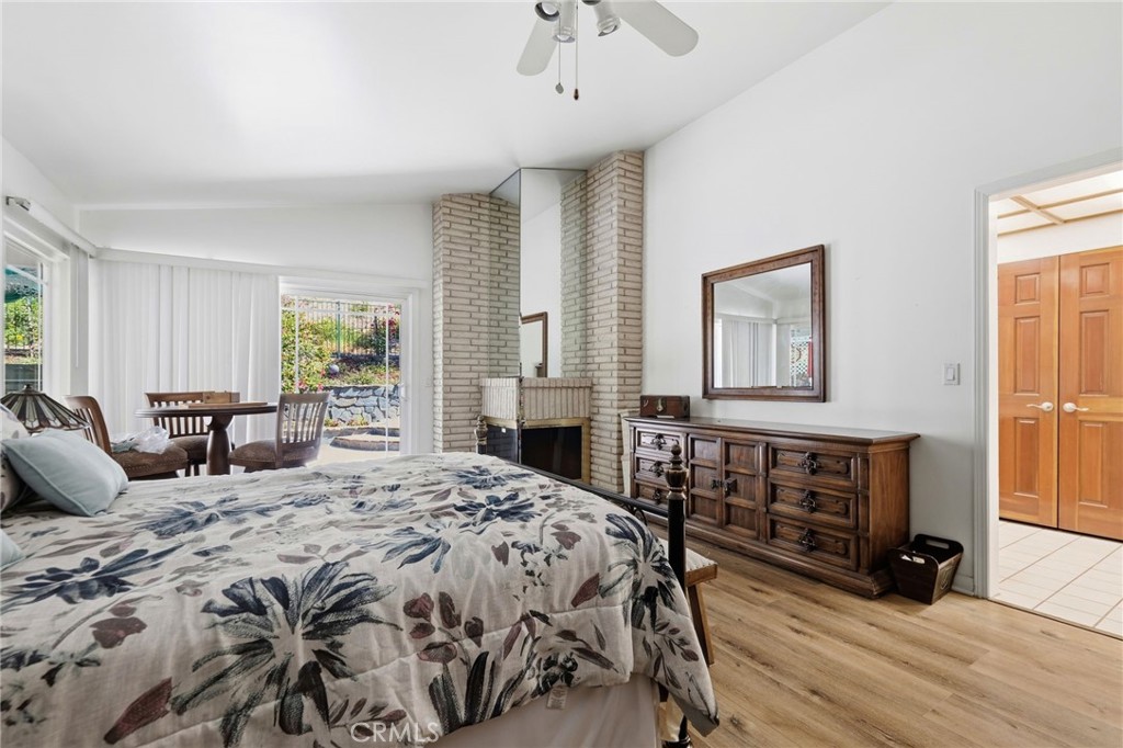 18233 Charlton Lane Porter Ranch, CA 91326 - Photo 13 of 40 a bedroom with a bed a large window and potted plants on the dresser