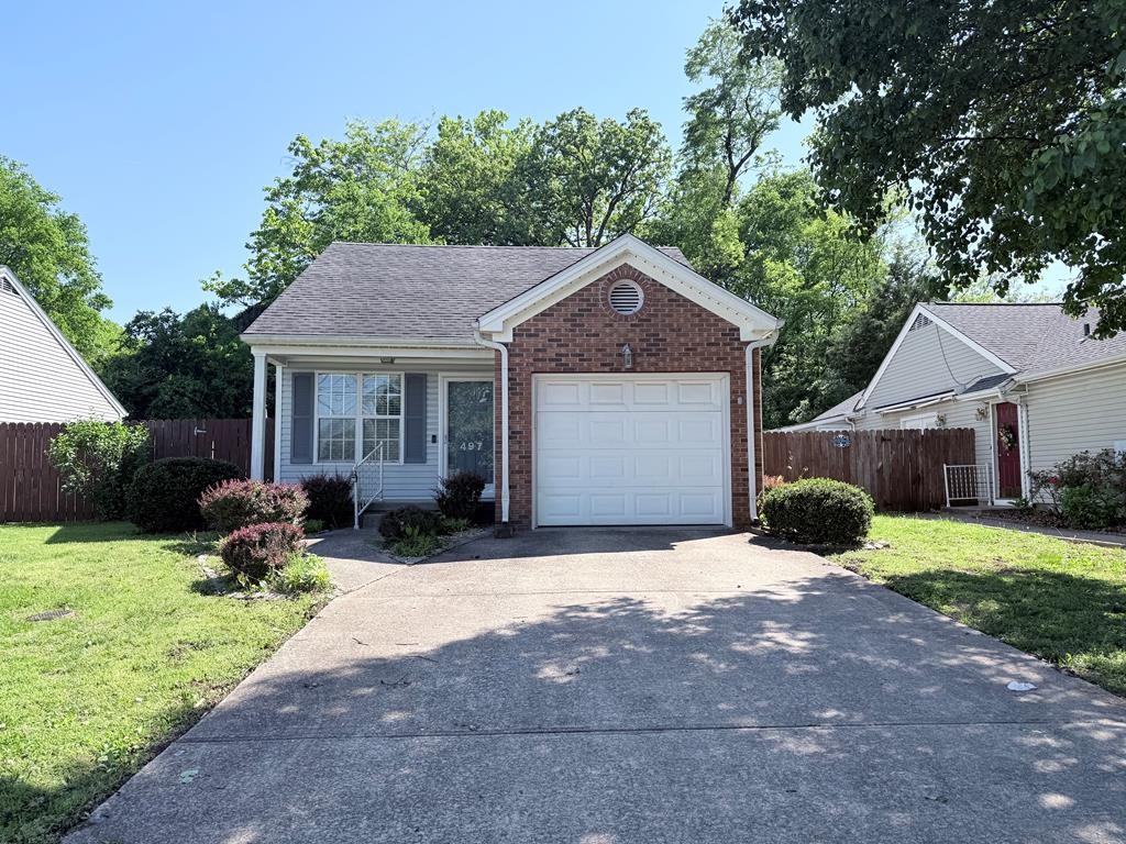497 Sivley Road Hopkinsville, KY 42240 - Photo 1 of 20 a front view of a house with a yard and garage