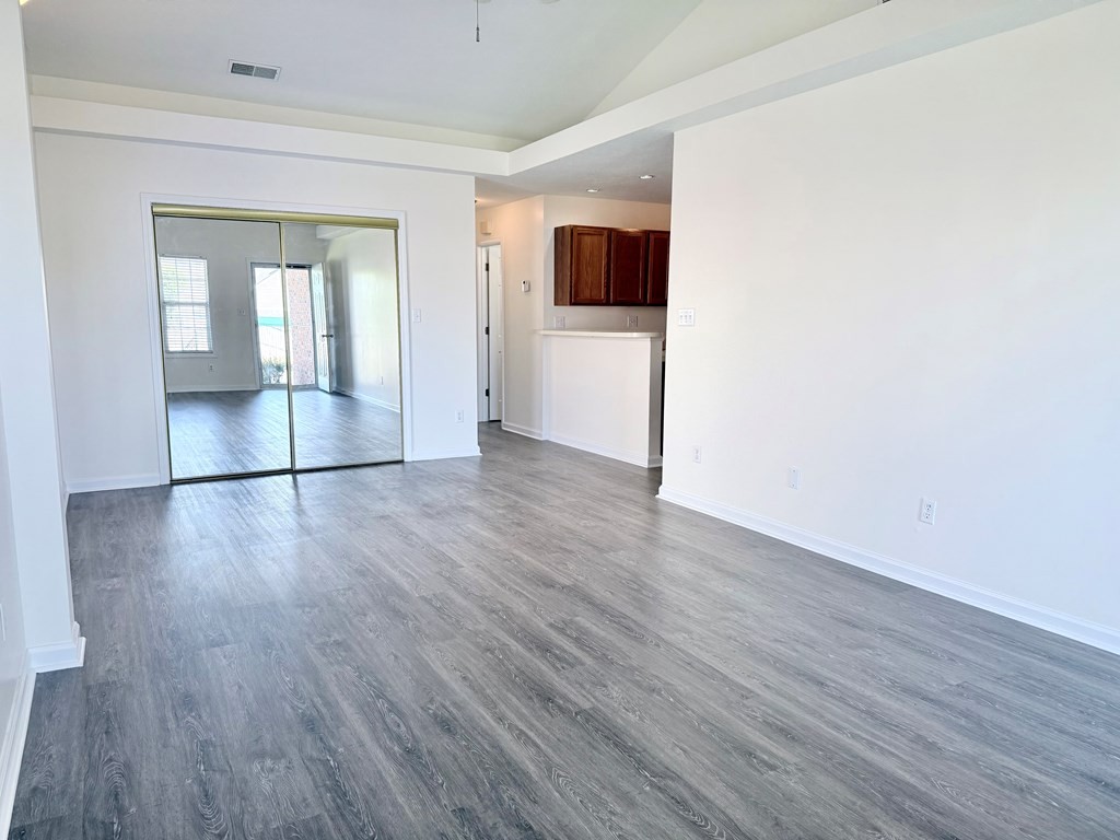 497 Sivley Road Hopkinsville, KY 42240 - Photo 4 of 20 an empty room with wooden floor and windows
