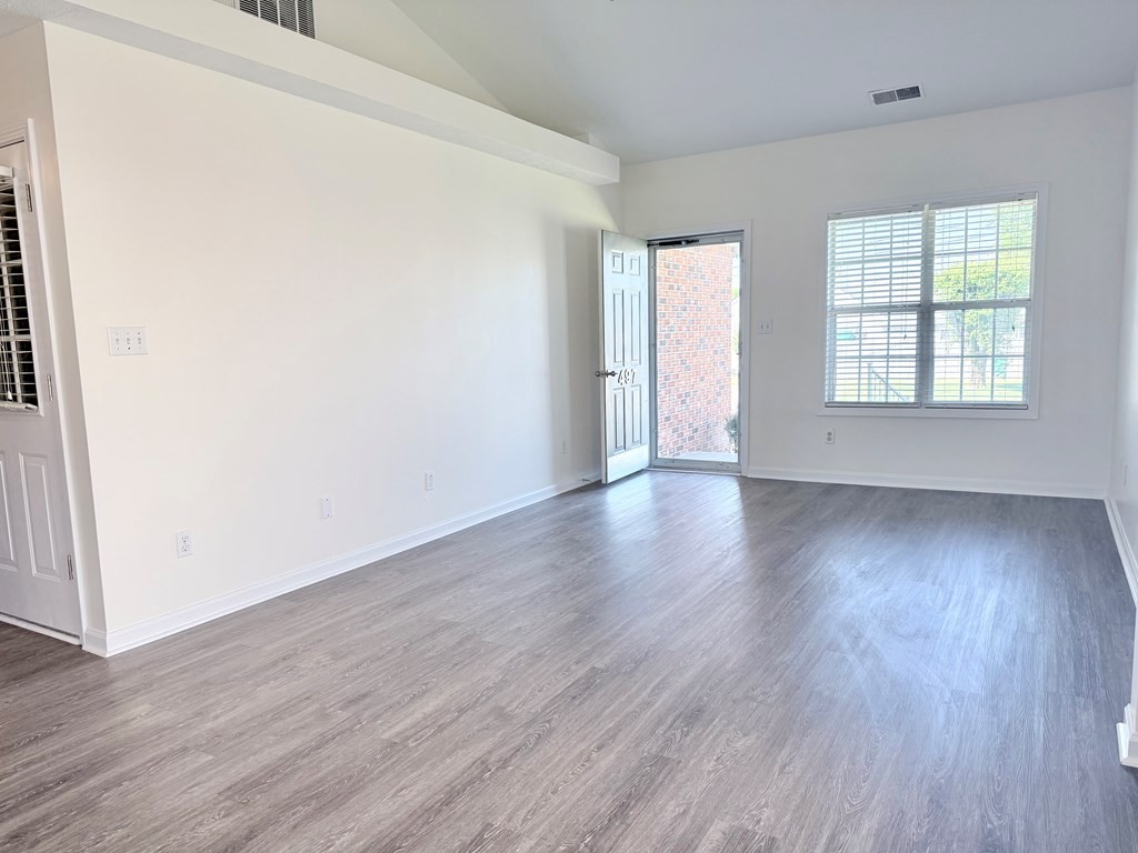 497 Sivley Road Hopkinsville, KY 42240 - Photo 5 of 20 an empty room with wooden floor and windows
