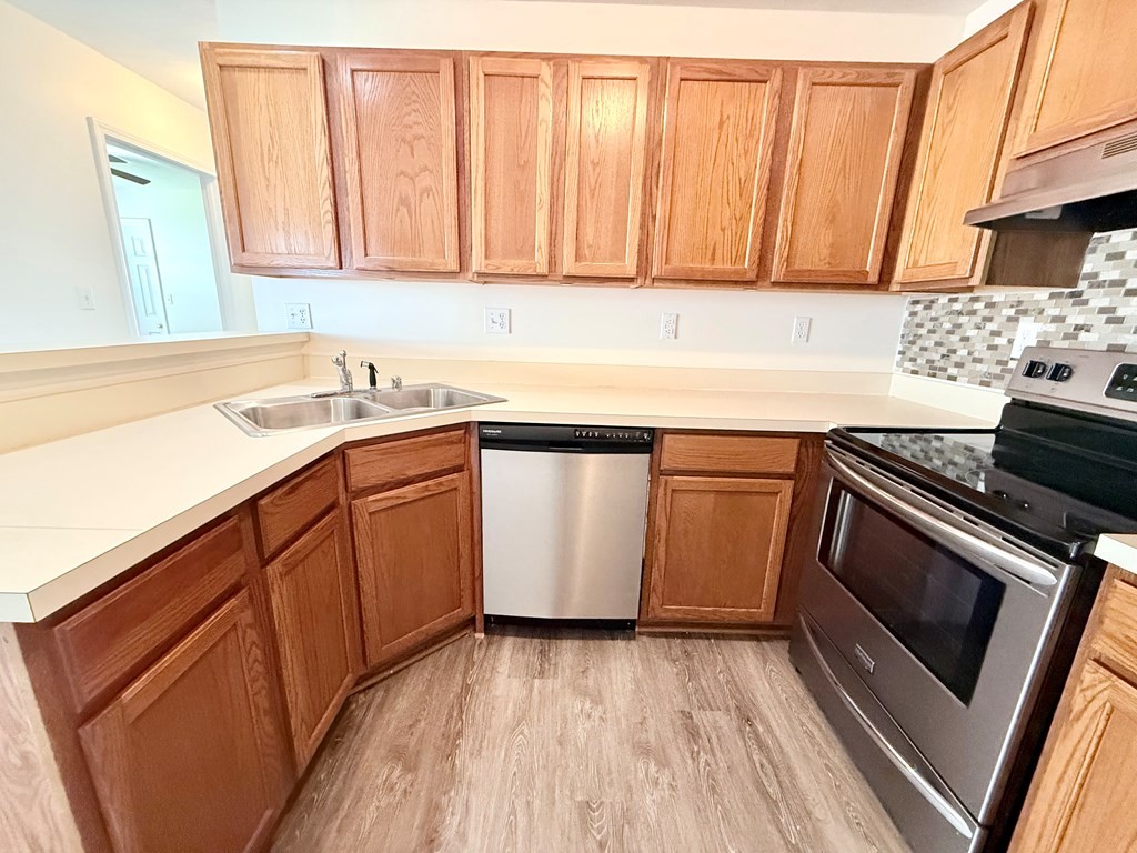 497 Sivley Road Hopkinsville, KY 42240 - Photo 7 of 20 a kitchen with a sink stove and cabinets