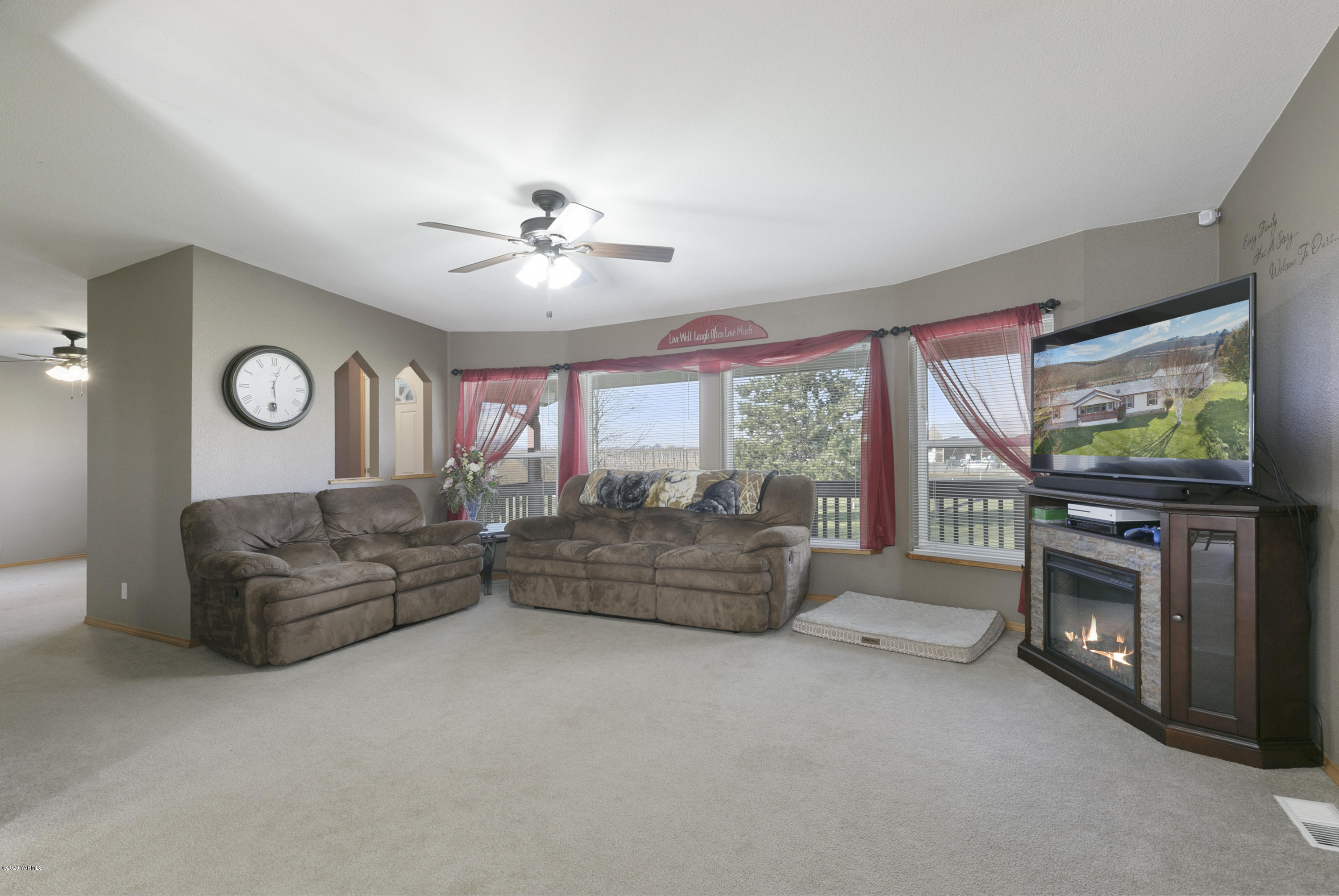 40 Desmarais Road Moxee, WA 98936 - Photo 4 of 23 a living room with furniture a flat screen tv and a fireplace
