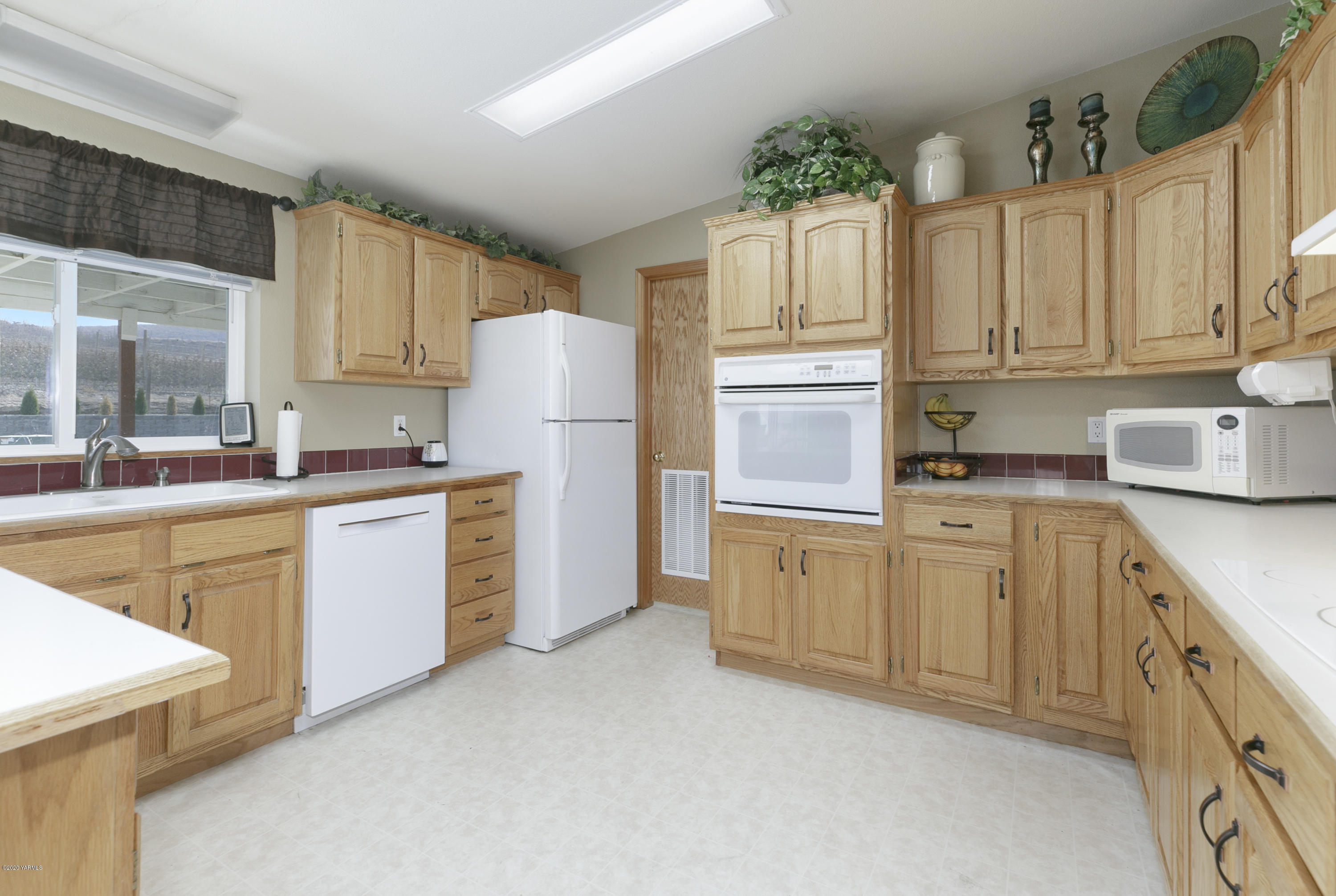 40 Desmarais Road Moxee, WA 98936 - Photo 8 of 23 a kitchen with granite countertop white cabinets and white appliances