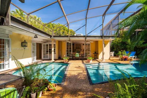 a view of a patio with table and chairs potted plants