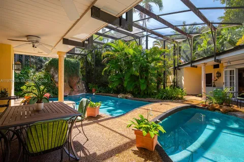 a backyard of a house with lots of green space and plants