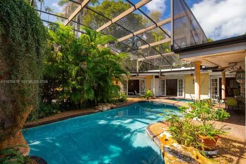 a view of a patio with table and chairs under an umbrella